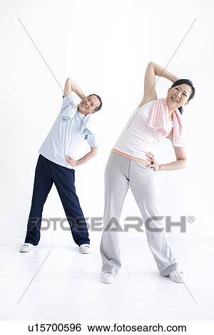 Stock Photograph - Couple stretching together. Fotosearch