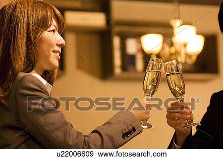 Stock Photo - Couple toasting wineglasses. Fotosearch