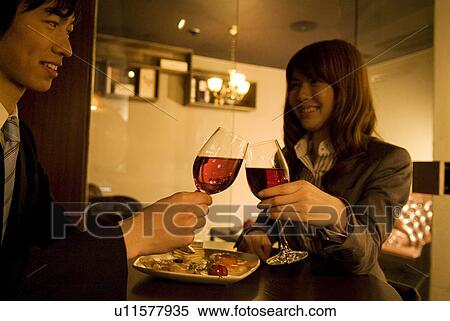 Stock Photography - Couple toasting wineglasses. Fotosearch