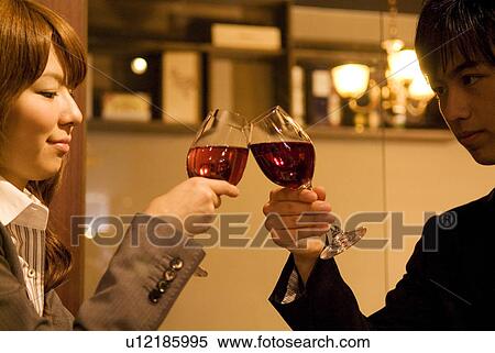 Couple toasting wineglasses View Large Photo Image Stock Photography - Couple toasting wineglasses. Fotosearch