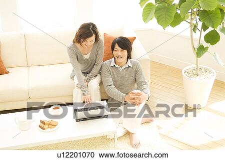 Stock Image - Couple using a laptop together. Fotosearch