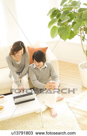 Stock Image - Couple using a laptop together. Fotosearch