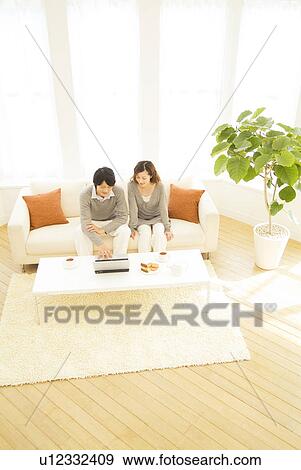 Stock Photo - Couple using a laptop together. Fotosearch
