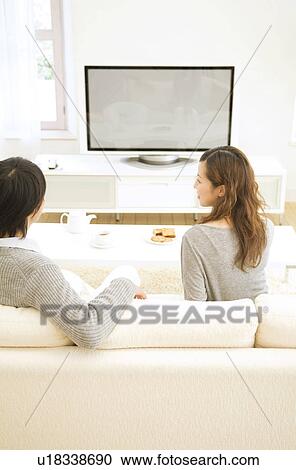 Couple watching television together View Large Photo Image Stock Image - Couple watching television together. Fotosearch