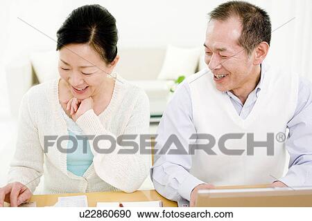 Couple working on their finances View Large Photo Image Stock Image - Couple working on their finances. Fotosearch