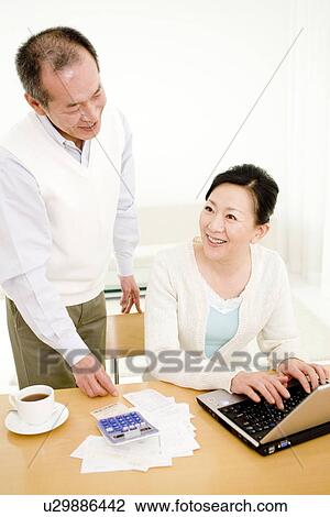 Couple working on their finances View Large Photo Image Stock Image - Couple working on their finances. Fotosearch