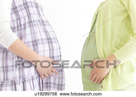 Cropped side view of two pregnant women standing facing each other View Large Photo Image Stock Photograph - Cropped side view of two pregnant women standing facing each other. Fotosearch