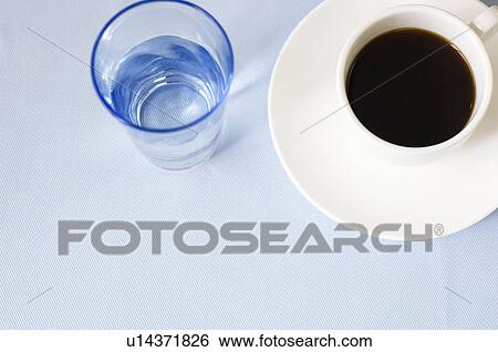 Stock Photograph - Cup of coffee and glass of water. Fotosearch