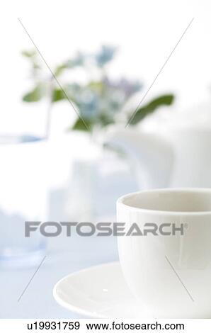 Stock Photo - Cup of coffee on table setting. Fotosearch