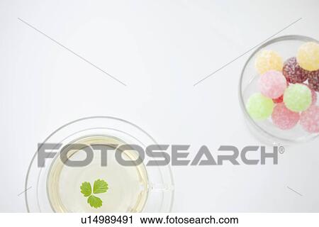 Cup of herbal tea and a glass of candy View Large Photo Image Stock Image - Cup of herbal tea and a glass of candy. Fotosearch