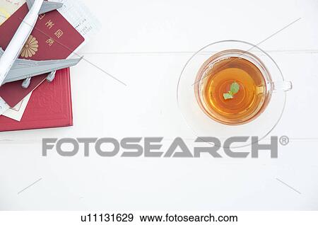 Cup of tea and a passport View Large Photo Image Stock Photo - Cup of tea and a passport. Fotosearch
