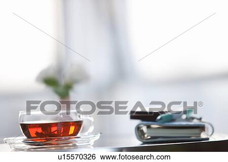 Cup of tea on a table with a cellphone and diary View Large Photo Image Stock Photograph - Cup of tea on a table with a cellphone and diary. Fotosearch
