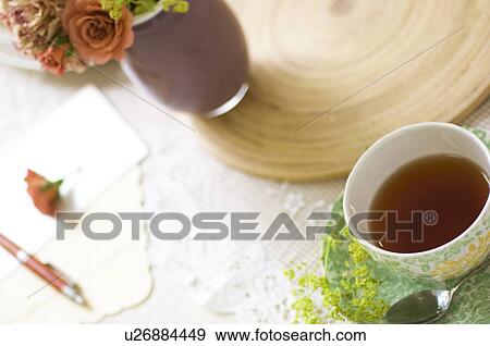 Cup of tea on table setting View Large Photo Image Stock Photo - Cup of tea on table setting. Fotosearch