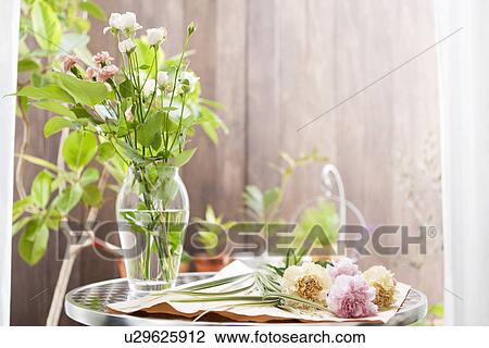 Stock Image - Cut flowers and a vase. Fotosearch