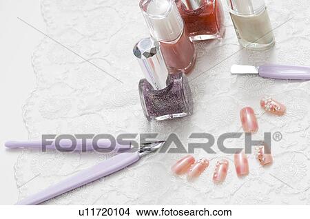 Picture - Decorated false nails with nail polish bottles and manicure tools. Fotosearch