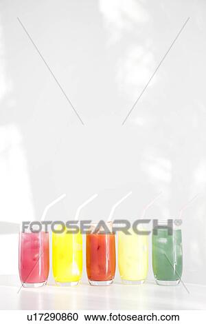 Stock Image - Different flavours of juice in a row. Fotosearch
