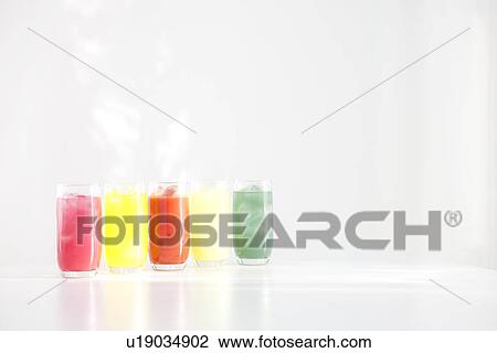 Different flavours of juice in a row View Large Photo Image Stock Image - Different flavours of juice in a row. Fotosearch