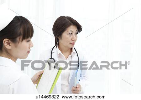 Doctor and nurse with clipboard and file View Large Photo Image Stock Image - Doctor and nurse with clipboard and file. Fotosearch
