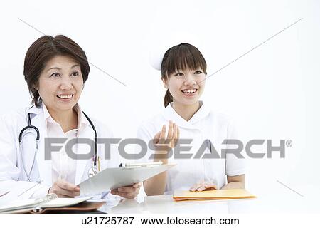 Stock Photo - Doctor and nurse with clipboard and file. Fotosearch