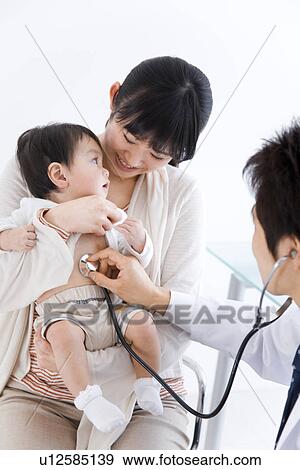Doctor examining a baby View Large Photo Image Stock Photo - Doctor examining a baby. Fotosearch