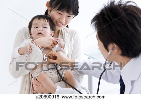 Stock Photograph - Doctor examining a baby. Fotosearch