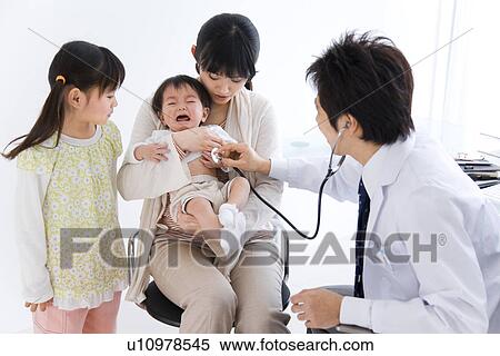 Stock Photography - Doctor examining a baby. Fotosearch