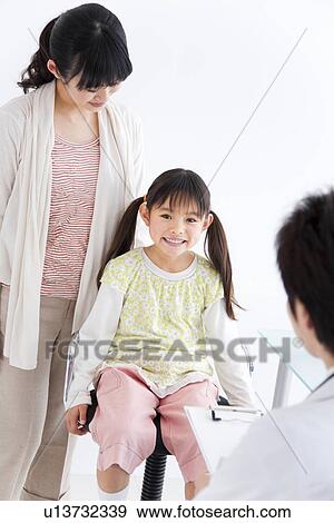 Doctor examining a child View Large Photo Image Stock Photo - Doctor examining a child. Fotosearch