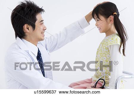 Doctor examining a child View Large Photo Image Stock Photo - Doctor examining a child. Fotosearch