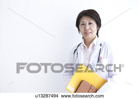 Doctor holding file View Large Photo Image Picture - Doctor holding file. Fotosearch