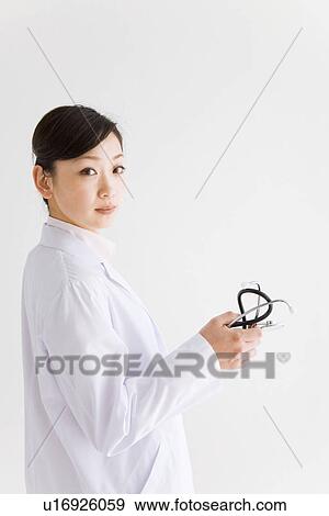 Stock Photo - Doctor holding stethoscope. Fotosearch