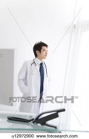 Doctor in his office View Large Photo Image Stock Image - Doctor in his office. Fotosearch