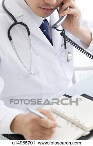 Doctor scheduling appointments over the telephone View Large Photo Image Stock Image - Doctor scheduling appointments over the telephone. Fotosearch
