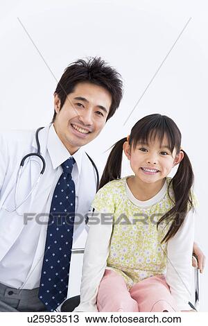 Doctor with a young girl View Large Photo Image Stock Image - Doctor with a young girl. Fotosearch