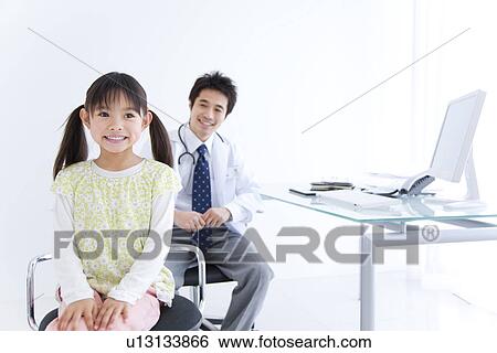 Stock Photograph - Doctor with a young girl. Fotosearch