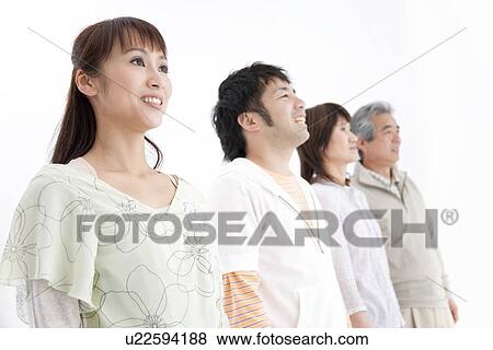 Family of four standing together View Large Photo Image Stock Photo - Family of four standing together. Fotosearch