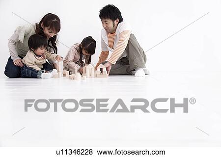 Family playing with toy blocks View Large Photo Image Stock Photo - Family playing with toy blocks. Fotosearch