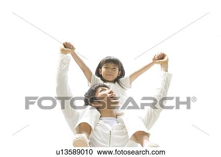 Stock Image - Father giving daughter a shoulder ride. Fotosearch