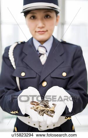 Picture - Female guard holding keys. Fotosearch