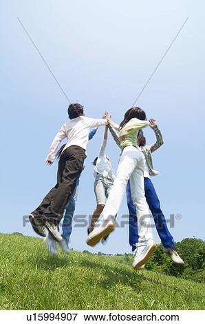 Stock Photo - Five young people doing a high five. Fotosearch