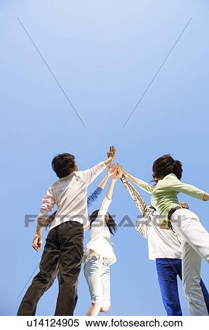 Five young people doing a high five View Large Photo Image Stock Photography - Five young people doing a high five. Fotosearch