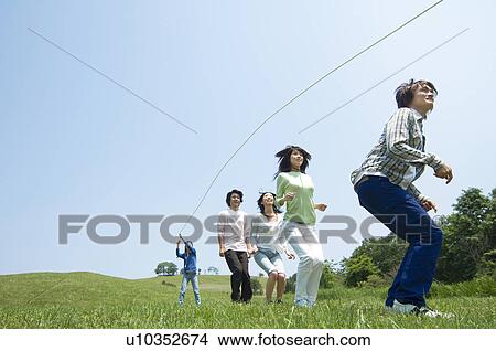 Picture - Five young people skipping. Fotosearch