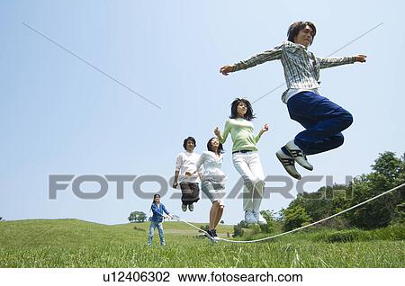 Stock Image - Five young people skipping. Fotosearch