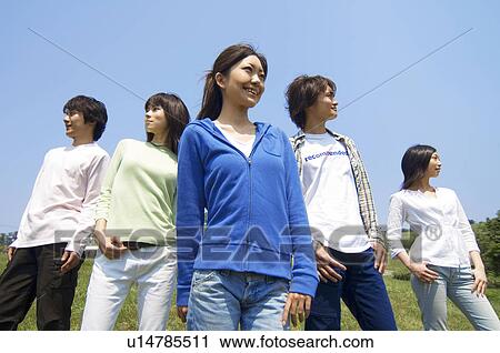 Five young people standing on grass hill View Large Photo Image Stock Image - Five young people standing on grass hill. Fotosearch