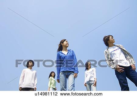 Stock Image - Five young people standing. Fotosearch
