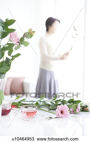 Flowers and tea with a mature woman in the background View Large Photo Image Stock Image - Flowers and tea with a mature woman in the background. Fotosearch