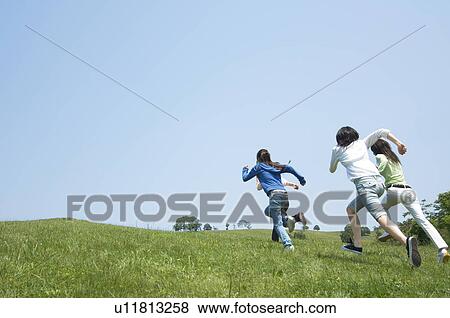 Four people running View Large Photo Image Stock Photo - Four people running. Fotosearch