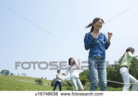 Four young people skipping View Large Photo Image Stock Photo - Four young people skipping. Fotosearch