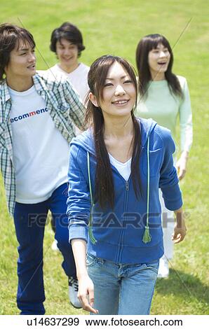 Stock Photo - Four young people walking. Fotosearch