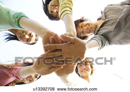 Stock Photo - Friends doing a team handshake. Fotosearch