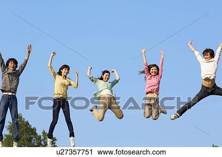 Stock Image - Friends jumping for joy. Fotosearch